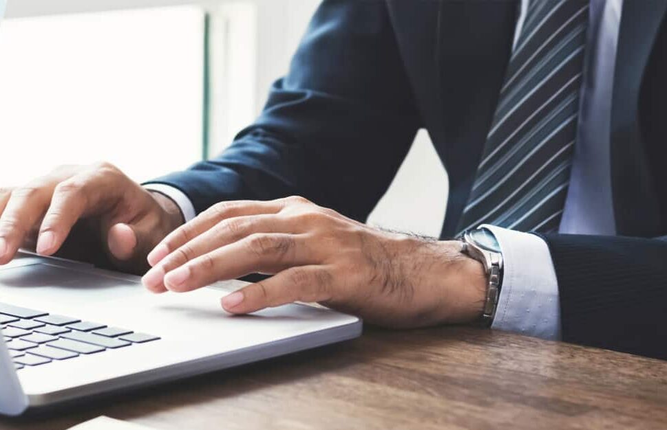 Cyber security compliance man in suit on keyboard